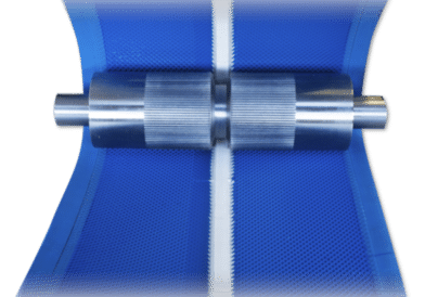 Underside of a conveyor belt with a V-guide engaging a grooved pulley