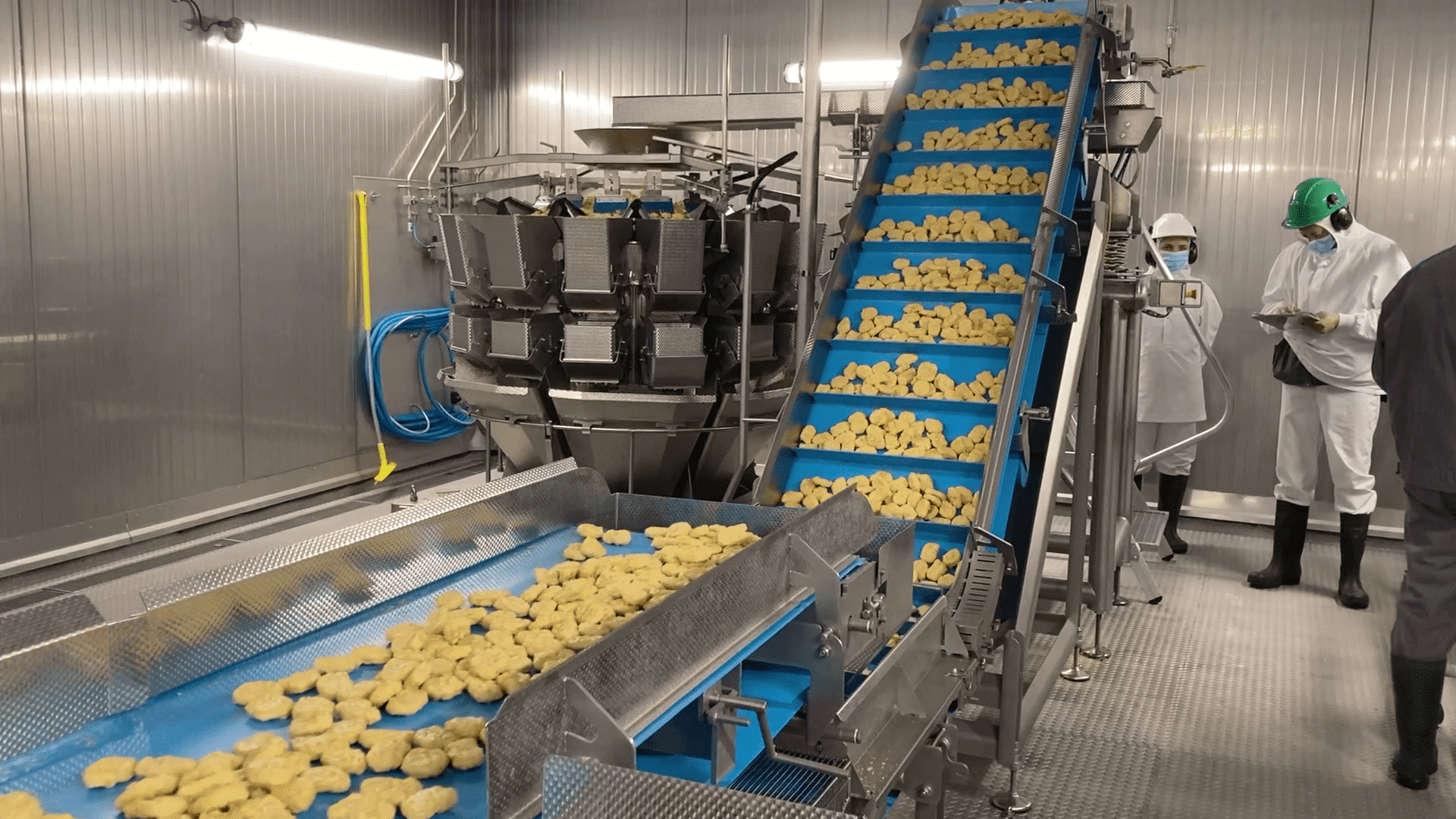 Stainless steel food packaging conveyor with a rotary encoder mounted near the drive assembly