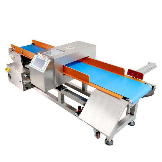In-line conveyor metal detector and reject station on a food production line